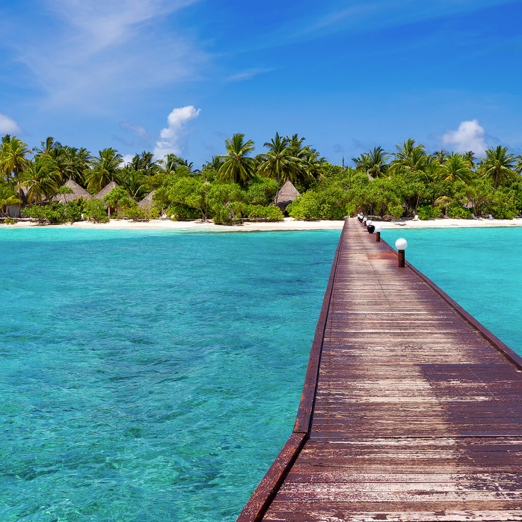 gangway on the sea with view of luxury hotel on island