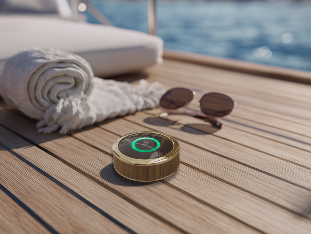 gest button on teak floor of a yacht with sunglasses and towel